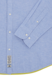 Light blue linen-blend long-sleeve shirt with white buttons on the placket and cuffs, and a yellow trim on the bottom hem.