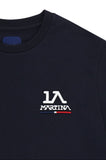 Navy blue short-sleeved crew neck t-shirt with a white embroidered 'LA MARTINA' logo and a blue, white, and red stripe on the