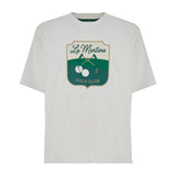 Optic white short-sleeved t-shirt with a green-trimmed crew neck and a front shield graphic featuring 'La Martina Polo Club',