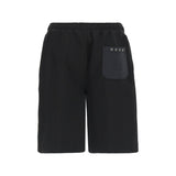 Black shorts with an elastic waistband and a dark grey patch pocket on the back right, featuring four silver-toned grommets a
