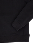 Black sweatshirt with ribbed cuffs and hem. Smooth fabric body and sleeves with visible side stitching.
