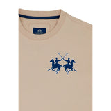Light tan short-sleeved crew neck t-shirt with a dark blue embroidered logo of two polo players on horses on the left chest.