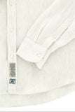 Cream-colored linen-blend shirt with thin vertical grey stripes, buttoned cuffs, and two fabric labels.