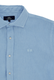 Light blue linen collared shirt with white buttons down the front and an embroidered logo on the left chest.