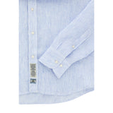 Light blue and white striped linen-blend long-sleeve shirt with white buttons, buttoned cuffs, and a curved hem.