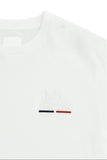 Optic white crew neck t-shirt with embroidered 'LA MARTINA' logo and two horizontal bars, one dark blue and one red, on the c