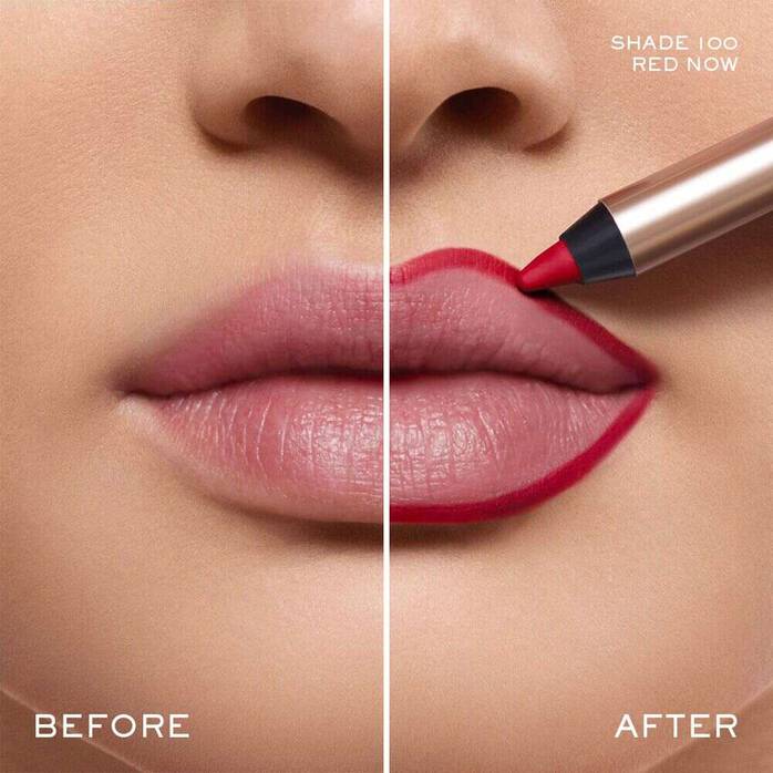 A gold-toned lip liner pencil with a red tip emerging from a black collar.