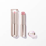 Light pink lipstick in a gold-toned, ribbed tube with a clear, ridged cap. A small, hexagonal pink container with 'LANCOME'.