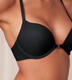Model close-up view of the Triumph Harmony Spotlight black push-up bra, showcasing the graphic lace and front-fastening detail. Available Online