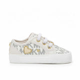 Michael Kors infant crib shoes in beige with all-over MK logo print, gold glitter heart detail, and metallic MK lace charm.