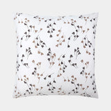 White square pillowcase with a scattered pattern of small, stylized dark brown and beige leaf-like motifs.