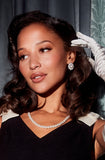 Front view of Santinni Dame earrings showing the silver and gold interlaced design with pearl drop.with model