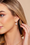 Front view of the Santinni Highgrove earrings showing the gold crystal stud and pearl drop.with model