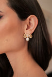 Model wearing the Sissi Bow and Pearl earrings to show scale and drape.