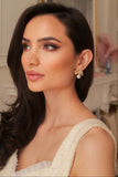 Model wearing the Sissi Bow and Pearl earrings to show scale and drape.