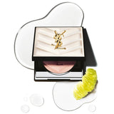 Open black compact with quilted white lid, gold-toned YSL logo, and circular pan of pink/rose gold gradient highlighter.