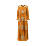 A long-sleeved mustard yellow maxi jalabiya by SHAIRA featuring tiers, ruffled trims, and heavy silver floral embroidery on the front.