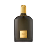 Dark ribbed glass perfume bottle with a gold-toned ribbed cap and front label.