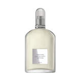 Clear ribbed glass perfume bottle with pale yellow liquid, silver-toned label, and a ribbed clear dome cap.