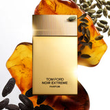 Rectangular perfume bottle with a matte gold body and a gold-toned cap featuring vertical ridges. Black text reads 'TOM FORD