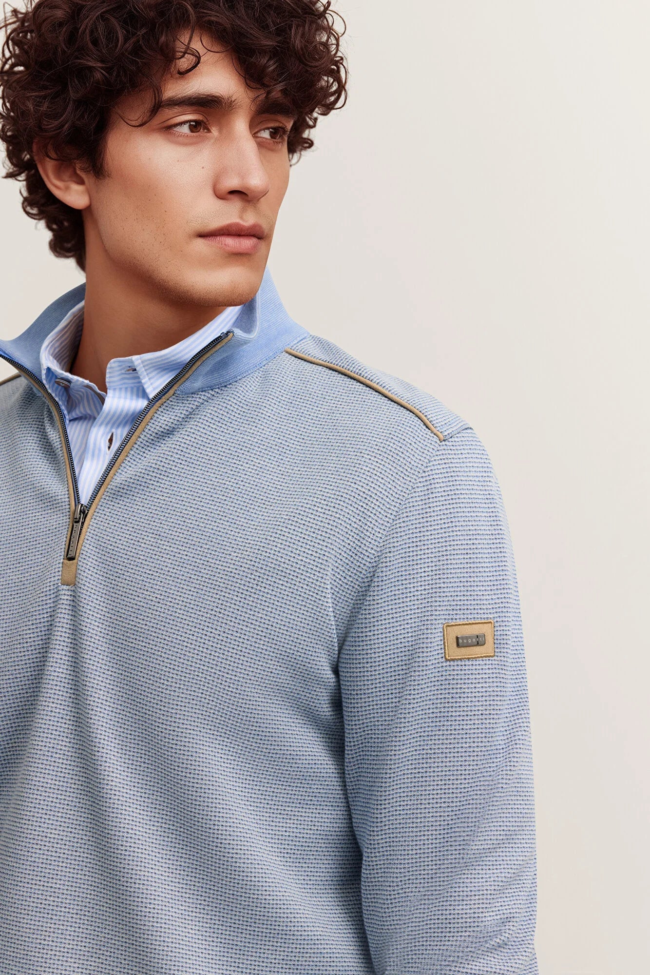 Light blue waffle knit quarter-zip sweatshirt with a stand-up collar, gold-toned zipper, tan piping, and a tan BOSS patch on