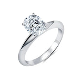 Silver-toned ring with a large, brilliant oval-cut clear cubic zirconia stone held by four prongs on a polished band.