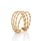 Gold-toned multi-band wave cuff bracelet with white pearl embellishments and an open back.