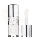 Clear lip gloss tube with silver-toned cap and YSL logo. Translucent white gloss and applicator with a paddle tip.