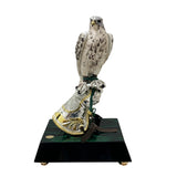 
صقر مطلي مع أجنحة مغلقة على كف يد فضي