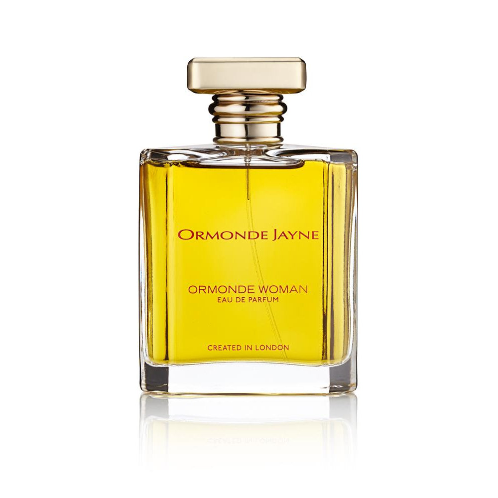 A clear glass bottle of Ormonde Jayne Ormonde Woman Eau De Parfum with a gold-colored cap and label.